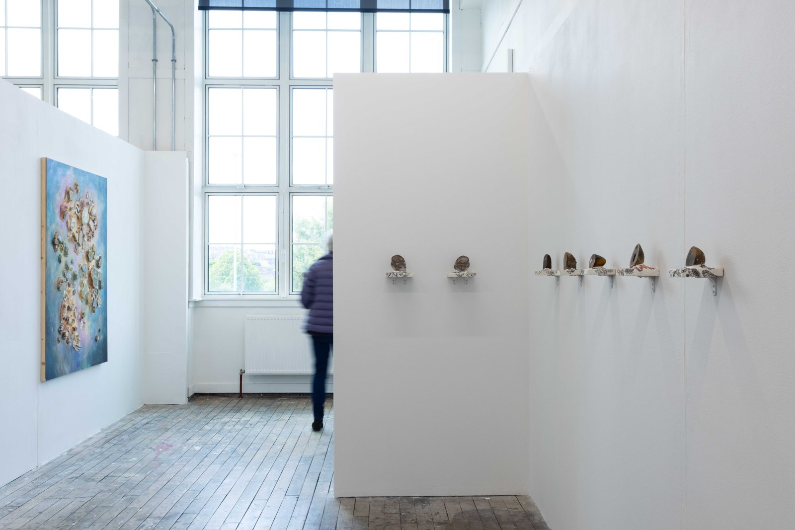 Exhibition view of From Attention to Flow, with a stone painting and wall-based installation