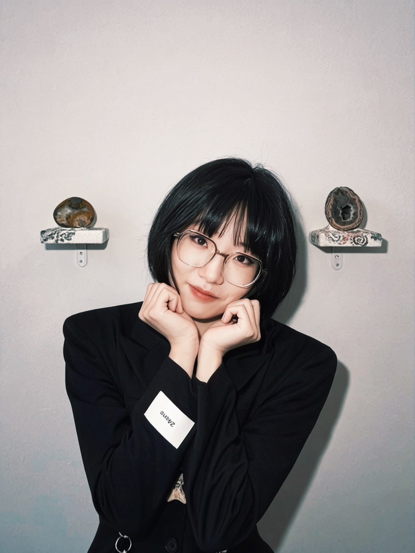 Portrait of Yuchen Liu with stone artworks