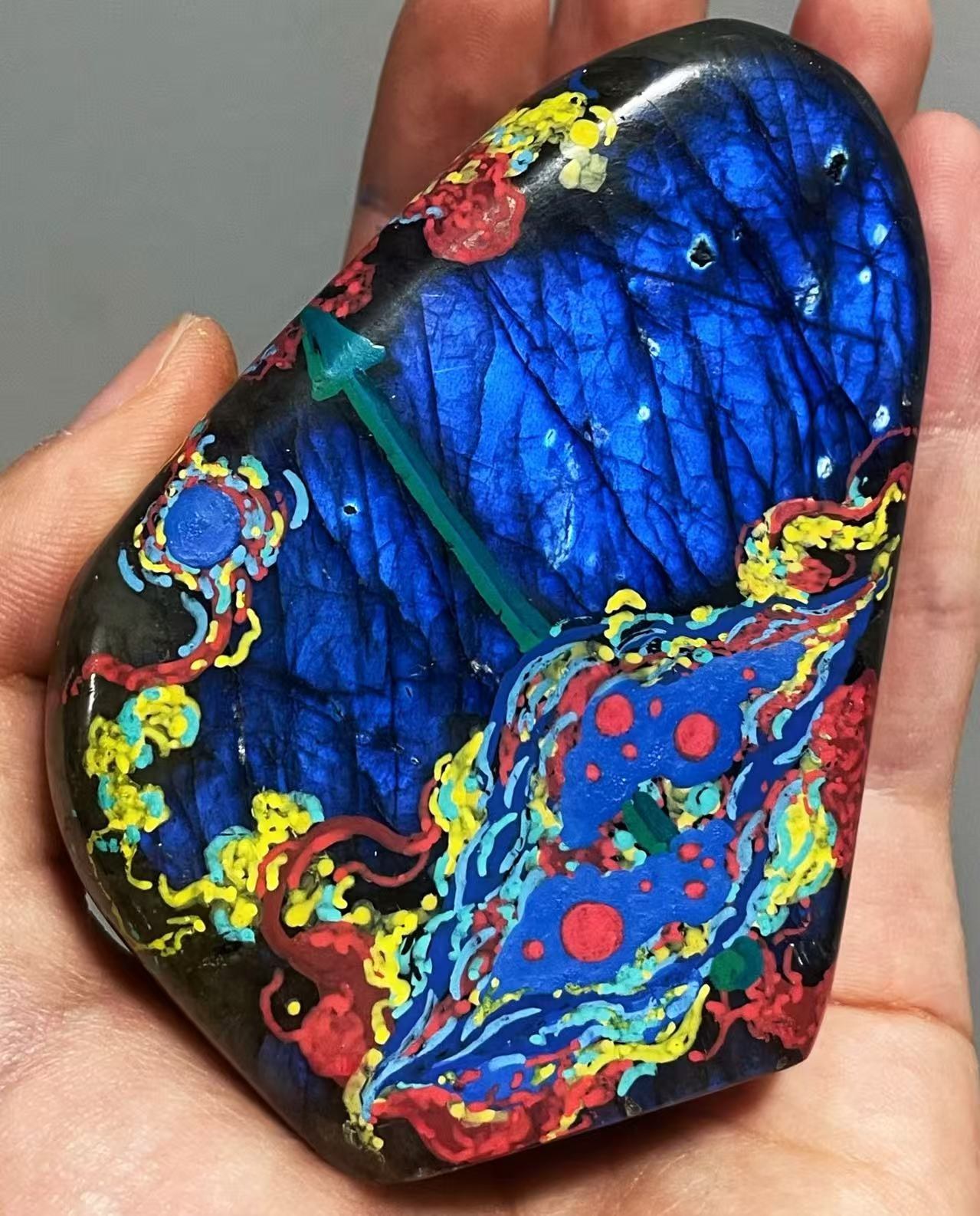 Close-up of a hand-held painted labradorite, 2025